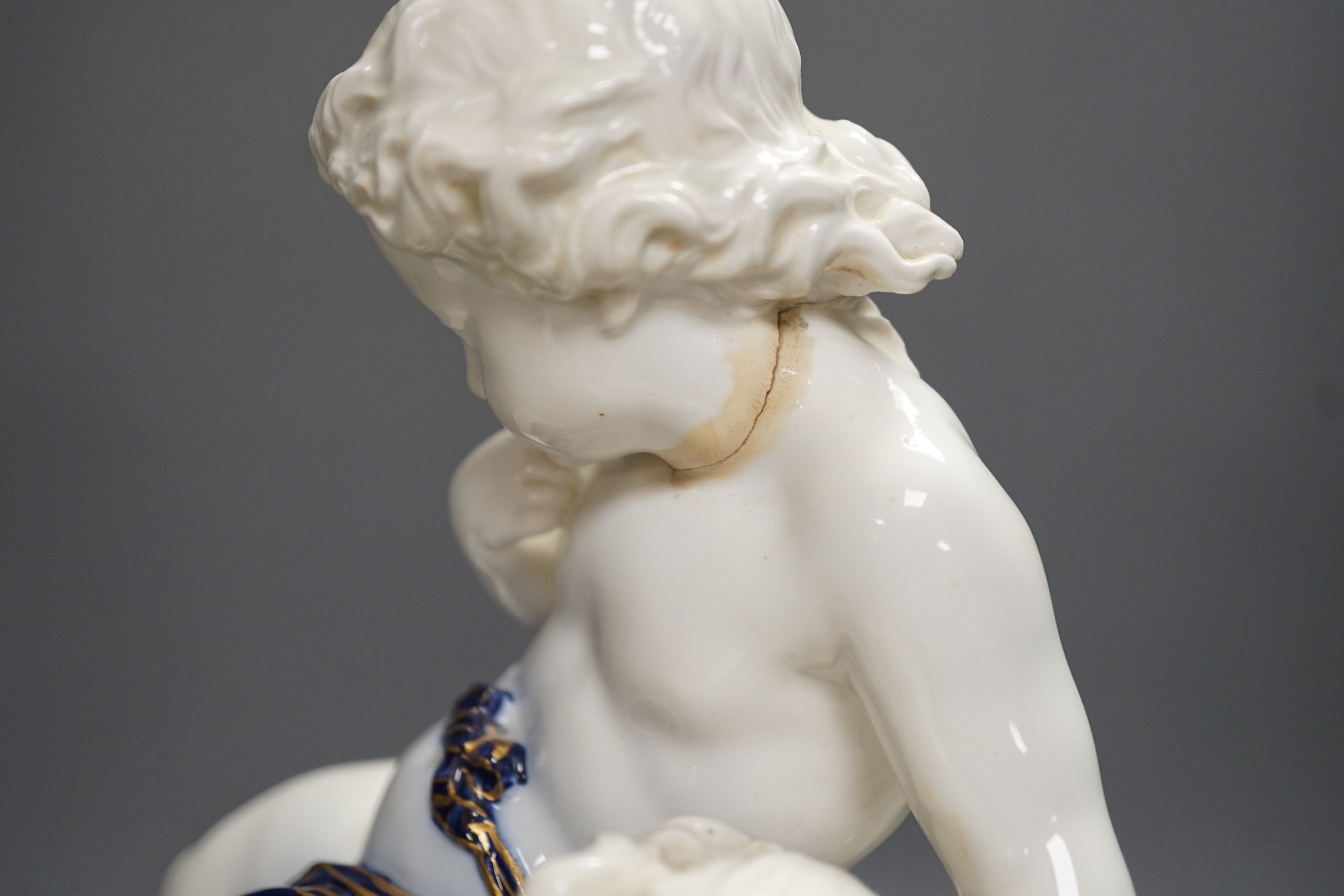 A Copeland porcelain putti seated on a shell centrepiece, modelled O. Hale, c.1877, 35cms high